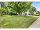 A lush front yard with mature trees and green grass provides excellent curb appeal to this lovely home at 13470 Shakamac Dr, Carmel, IN 46032