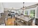 Well-lit kitchen with modern appliances, white cabinetry, and an adjacent dining area and backyard access at 13470 Shakamac Dr, Carmel, IN 46032