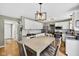 Bright kitchen featuring white cabinets, granite countertops, stainless steel appliances, and an eating area at 13470 Shakamac Dr, Carmel, IN 46032