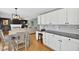 The kitchen features sleek white cabinets, granite countertops, and a desk area adjacent to a comfortable living area at 13470 Shakamac Dr, Carmel, IN 46032