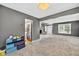 Spacious carpeted living room that transitions into a kitchen area, perfect for modern living at 13470 Shakamac Dr, Carmel, IN 46032