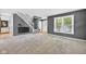 A bright and airy living room features carpeted floors, a staircase, and plenty of natural light at 13470 Shakamac Dr, Carmel, IN 46032