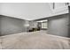 Spacious living room with neutral carpet, gray walls, and plenty of natural light from the large windows at 13470 Shakamac Dr, Carmel, IN 46032