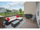 Back deck with a glass coffee table, sectional couch with red pillows, and a grill at 13884 Wendessa Dr, Fishers, IN 46038