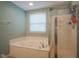 Bright bathroom featuring a soaking tub and a glass enclosed shower at 13884 Wendessa Dr, Fishers, IN 46038
