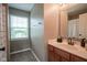 Bathroom featuring a single sink vanity, a window with blinds, and a shower/tub at 13884 Wendessa Dr, Fishers, IN 46038