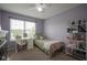 Bright bedroom featuring a single bed, a desk and chair, and a white shelving unit at 13884 Wendessa Dr, Fishers, IN 46038