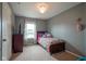 Bedroom featuring a dresser and a window with patterned curtains next to a twin bed at 13884 Wendessa Dr, Fishers, IN 46038