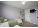 Comfortable bedroom with a twin bed, white shelving unit, and a mounted television at 13884 Wendessa Dr, Fishers, IN 46038