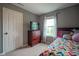 Cozy bedroom with a dresser, window with patterned curtains, and colorful bedding at 13884 Wendessa Dr, Fishers, IN 46038