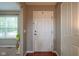 Bright and airy foyer with hardwood floors, a white front door, and a view into an adjacent carpeted room at 13884 Wendessa Dr, Fishers, IN 46038
