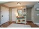 Inviting foyer with hardwood floors, a console table, a decorative mirror, and multiple entryways at 13884 Wendessa Dr, Fishers, IN 46038
