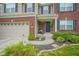 Inviting front entrance with a brick facade, hanging flower baskets, and a welcoming 'Home' sign at 13884 Wendessa Dr, Fishers, IN 46038