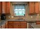 Kitchen with granite counters, tiled backsplash, stainless dishwasher, and wooden cabinets at 13884 Wendessa Dr, Fishers, IN 46038