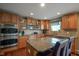 Kitchen features stainless steel appliances, wood cabinets, granite countertops, and large windows at 13884 Wendessa Dr, Fishers, IN 46038