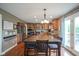 Spacious kitchen features stainless steel appliances, wood cabinets, granite countertops, and an island at 13884 Wendessa Dr, Fishers, IN 46038