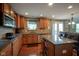 This kitchen features stainless steel appliances, wood cabinets, granite countertops, and a kitchen island at 13884 Wendessa Dr, Fishers, IN 46038