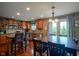 This kitchen has stainless steel appliances, wood cabinets, a granite countertop, and lots of natural light at 13884 Wendessa Dr, Fishers, IN 46038