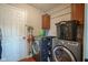 Laundry room with full size washer and dryer, storage cabinet and hanging rack at 13884 Wendessa Dr, Fishers, IN 46038