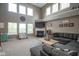 Spacious living room with high ceilings, a fireplace, a large gray sectional, and plenty of natural light at 13884 Wendessa Dr, Fishers, IN 46038