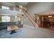 Open-concept living room with staircase, hardwood floors, and large windows for plenty of natural light at 13884 Wendessa Dr, Fishers, IN 46038