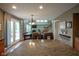 Open floor plan with dining table, living room fireplace and doors to the outside deck at 13884 Wendessa Dr, Fishers, IN 46038