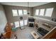 Bright living room boasts fireplace, large windows, and vaulted ceiling, creating an inviting space at 13884 Wendessa Dr, Fishers, IN 46038