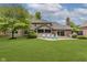 Large backyard with a patio and blue Adirondack chairs, perfect for outdoor entertaining at 1393 Stoney Creek Cir, Carmel, IN 46032