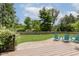 Expansive backyard with lush greenery, wooden deck, and seating area at 1393 Stoney Creek Cir, Carmel, IN 46032
