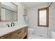 Stylishly renovated bathroom with a wood vanity, marble countertop, and natural light at 1393 Stoney Creek Cir, Carmel, IN 46032