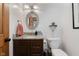 Cozy bathroom with dark cabinets, granite countertop, and decorative lighting at 1393 Stoney Creek Cir, Carmel, IN 46032