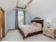 Charming bedroom with a tray ceiling, ceiling fan, and a large window at 1393 Stoney Creek Cir, Carmel, IN 46032
