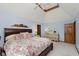 Comfortable bedroom with a floral bedspread, a tray ceiling, and two dressers at 1393 Stoney Creek Cir, Carmel, IN 46032
