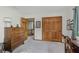 Bedroom showcasing a wooden dresser, closet, and view into the hallway with carpet floors at 1393 Stoney Creek Cir, Carmel, IN 46032