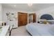 Bright bedroom featuring a soft blue bedspread, a large closet, and a view into the hall at 1393 Stoney Creek Cir, Carmel, IN 46032