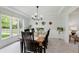 Bright dining room with garden view, modern light fixture, and seating for six at 1393 Stoney Creek Cir, Carmel, IN 46032