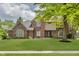 Charming brick two-story home featuring lush front lawn and mature trees in a desirable location at 1393 Stoney Creek Cir, Carmel, IN 46032