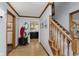 Elegant foyer featuring hardwood floors, a wooden staircase, and a view into the kitchen at 1393 Stoney Creek Cir, Carmel, IN 46032