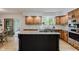 Stylish kitchen featuring marble backsplash, granite counters, and center island at 1393 Stoney Creek Cir, Carmel, IN 46032