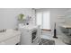 Bright laundry room featuring washer, dryer, sink, practical storage and updated flooring at 1393 Stoney Creek Cir, Carmel, IN 46032