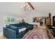 Expansive living room with seamless open layout, fireplace, and large windows to the backyard at 1393 Stoney Creek Cir, Carmel, IN 46032
