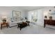 Inviting living room featuring a comfortable sofa, neutral decor, and a bright window with curtains at 1393 Stoney Creek Cir, Carmel, IN 46032