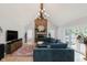 Spacious living room featuring vaulted ceilings, brick fireplace, and modern lighting fixture at 1393 Stoney Creek Cir, Carmel, IN 46032