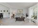 Inviting living room featuring neutral decor, plush carpeting, and a bright window with sheer curtains at 1393 Stoney Creek Cir, Carmel, IN 46032