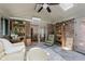 Relaxing sunroom with exposed brick, comfortable seating, and access to the dining room at 1393 Stoney Creek Cir, Carmel, IN 46032