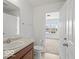 Bright bathroom featuring a single sink vanity and a view into an adjacent bedroom at 1456 Willow Tree Ln, Sheridan, IN 46069