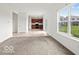 Open-concept living room with kitchen view and ample natural light at 1456 Willow Tree Ln, Sheridan, IN 46069