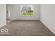 Comfortable living room featuring neutral carpet and a view of the front yard at 1456 Willow Tree Ln, Sheridan, IN 46069