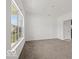 Spacious living room with plush carpeting and a large window offering ample natural light at 1456 Willow Tree Ln, Sheridan, IN 46069