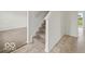 Inviting entryway featuring carpeted stairs and neutral-toned tile flooring at 1456 Willow Tree Ln, Sheridan, IN 46069